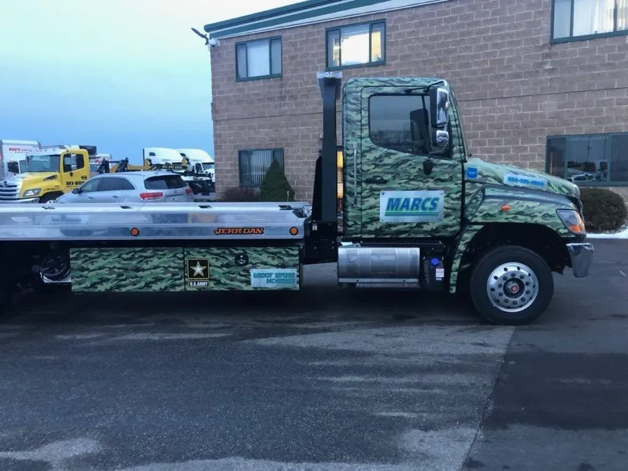 Camouflage-wrapped rollback truck