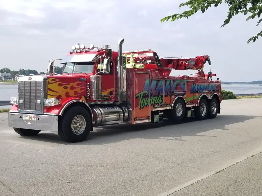 Marc's red heavy-duty wrecker by the water